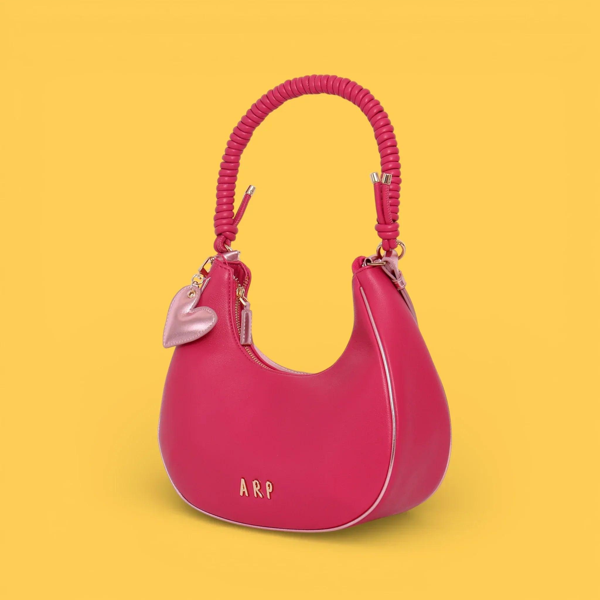 Bolso rosa fucsia con asa trenzada de cordón y bolsillo frontal con cierre