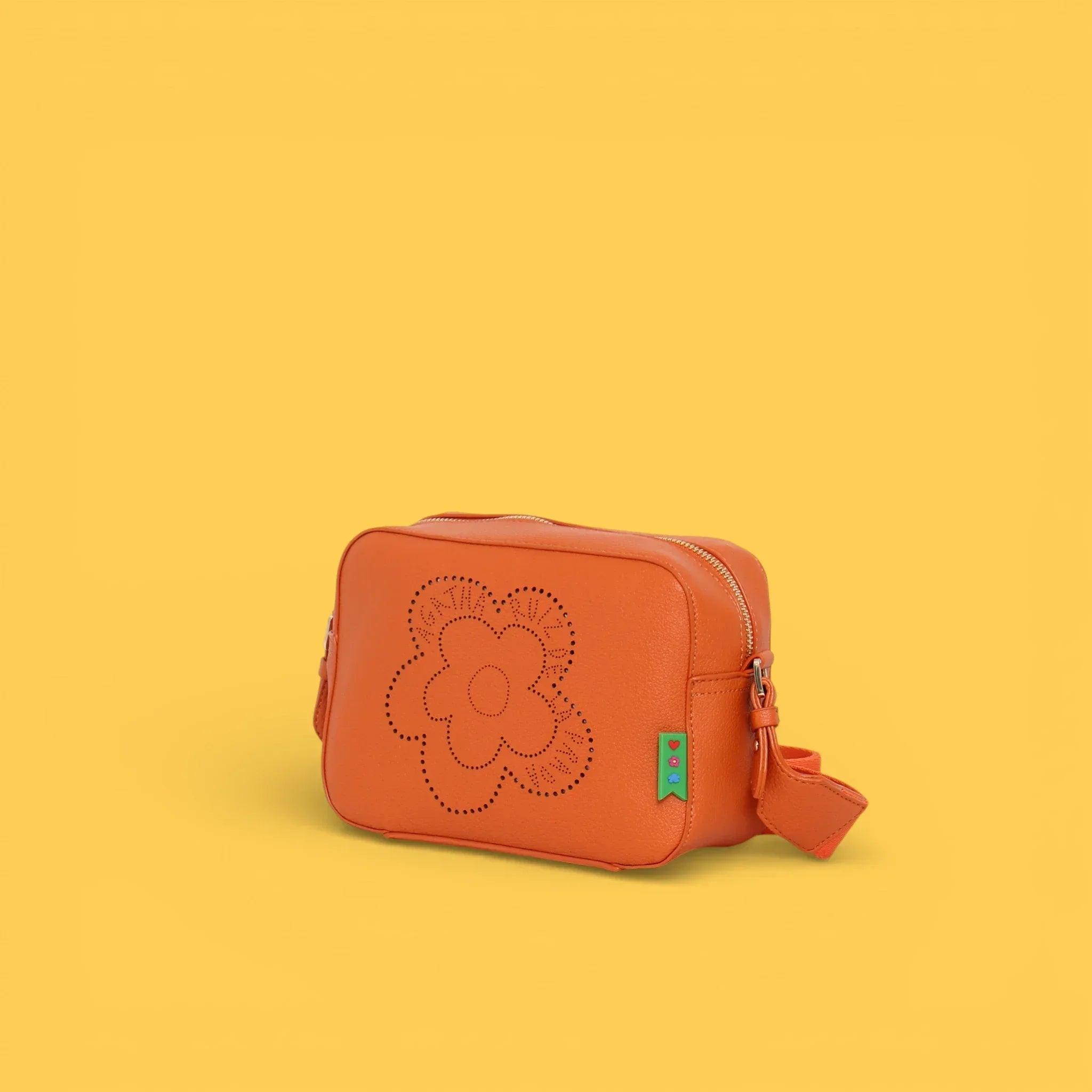 Bandolera naranja de cuero con flor calada, colgante verde y tiras