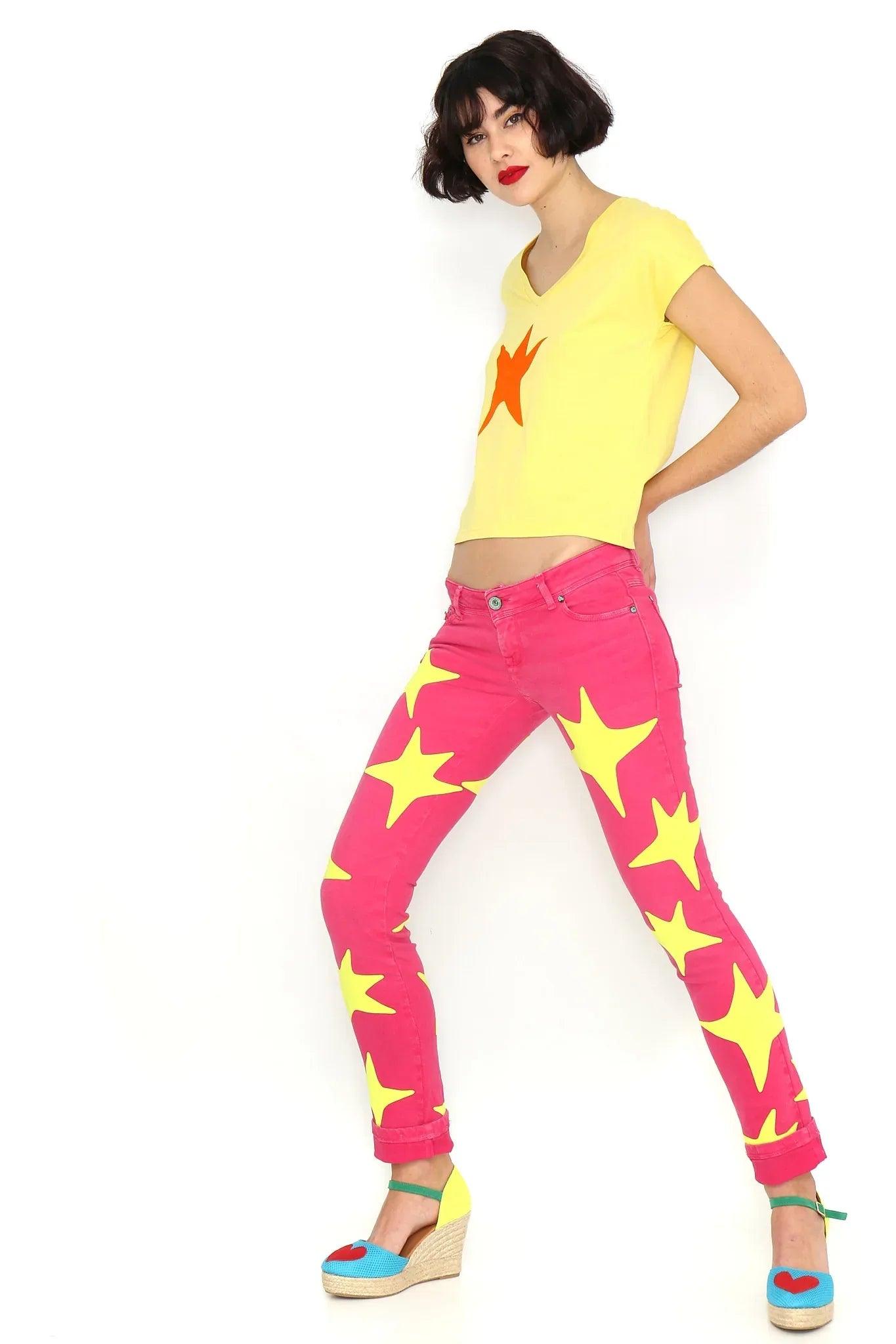 Camiseta amarilla con estrella naranja en el pecho, cuello en V y manga corta.