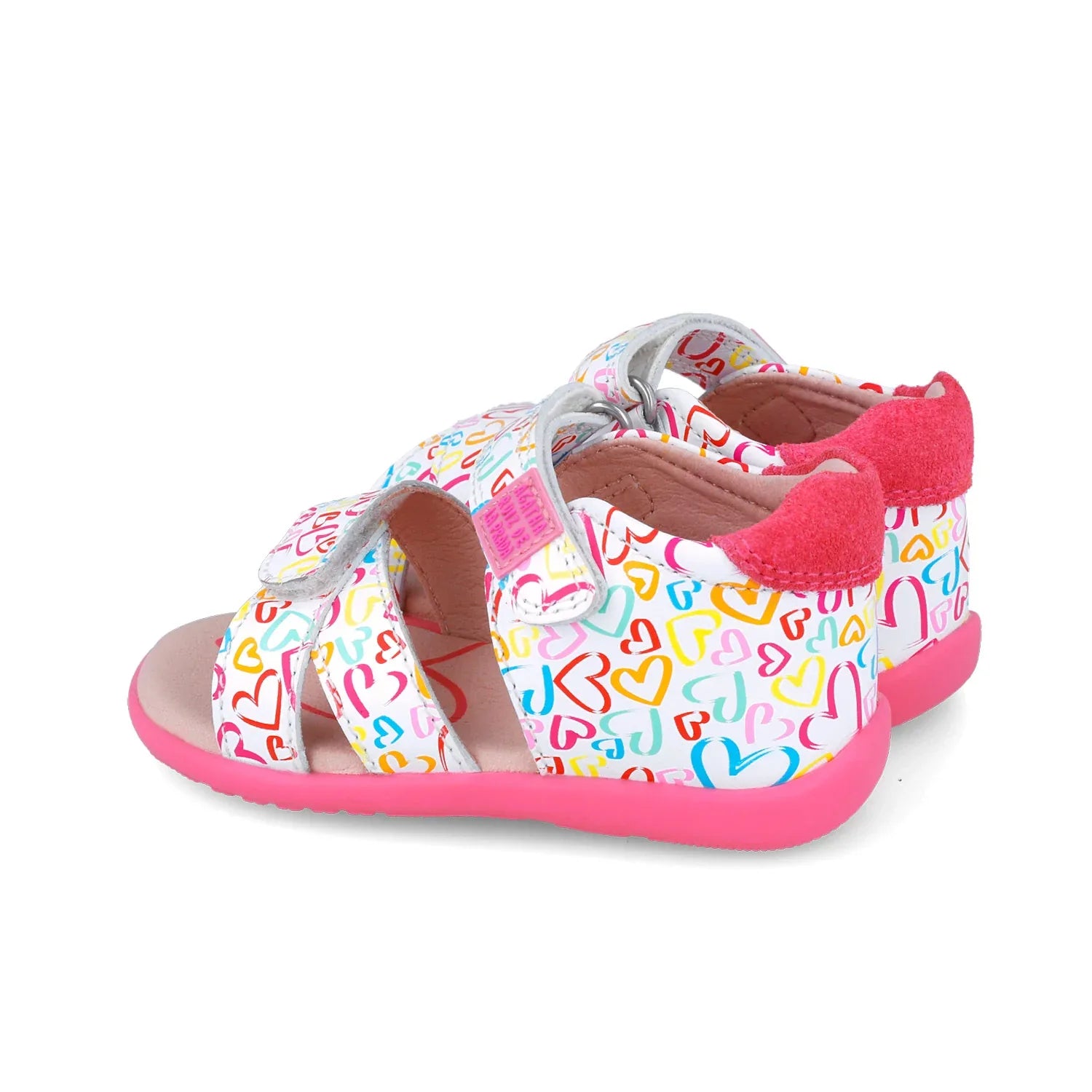 Sandalia infantil estampada con tiras ajustables y hebilla, suela fucsia visible.