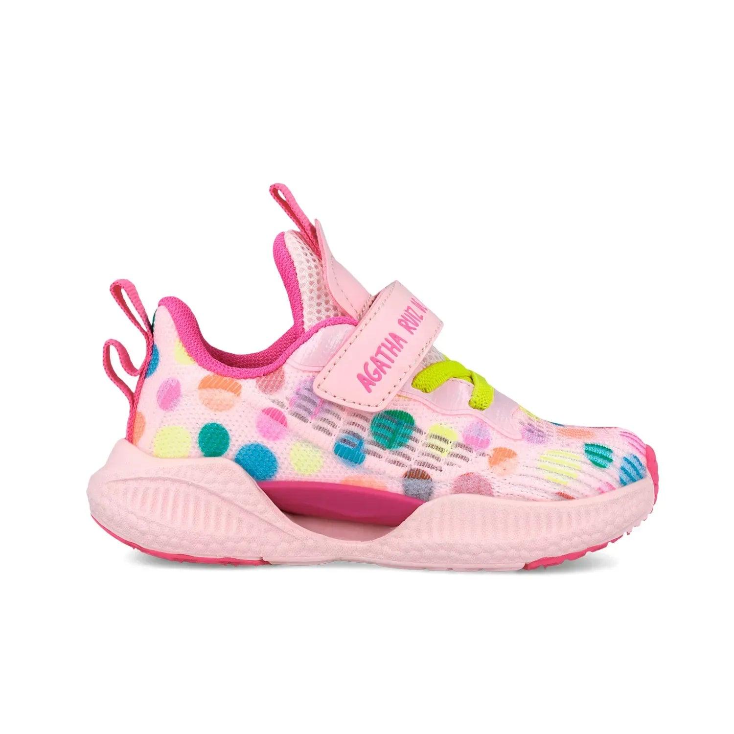 Zapatilla deportiva rosa con estampado de puntos, tira con velcro y suela estriada
