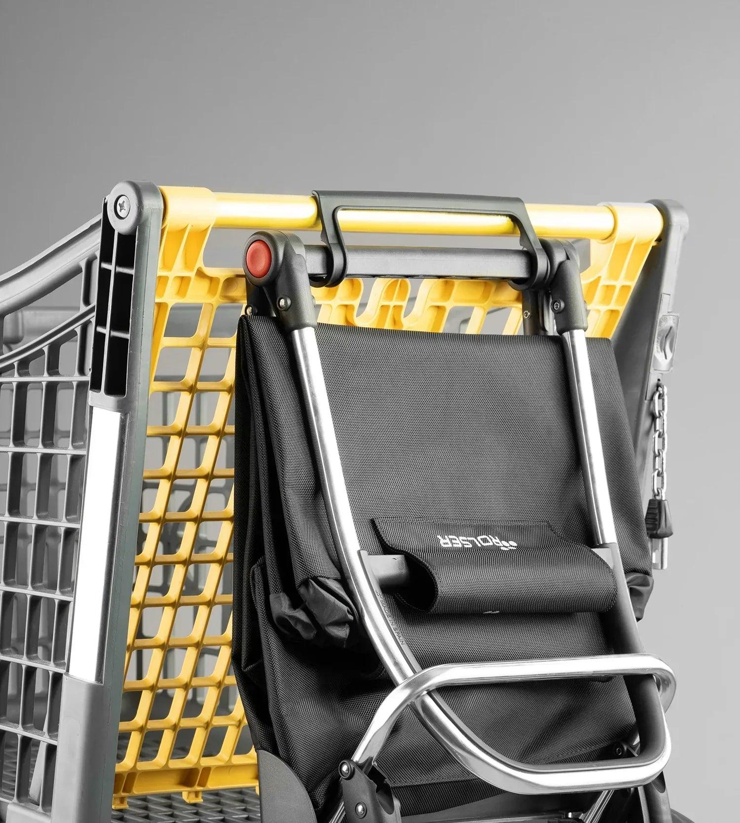 Carro plegable con estructura amarilla y asiento negro acolchado