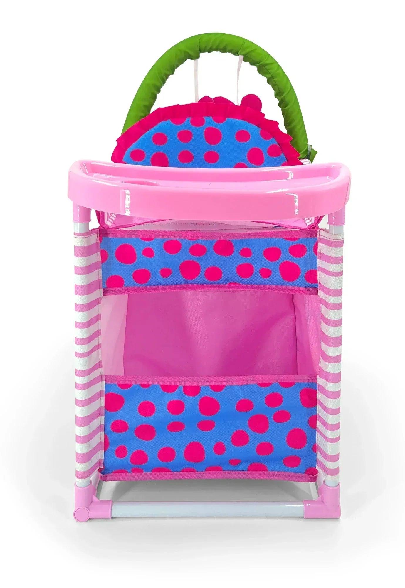 Cuna cambiadora rosa con asa verde, bandeja superior y paneles azul y magenta