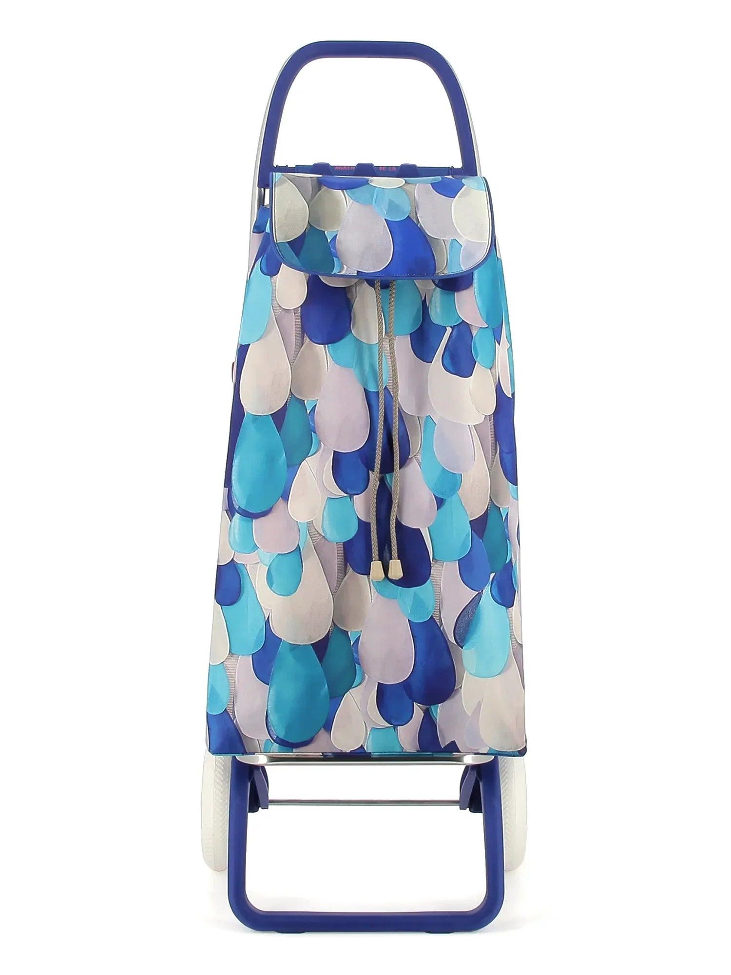Carro plegable para bebé con estampado azul y blanco, arnés y capota