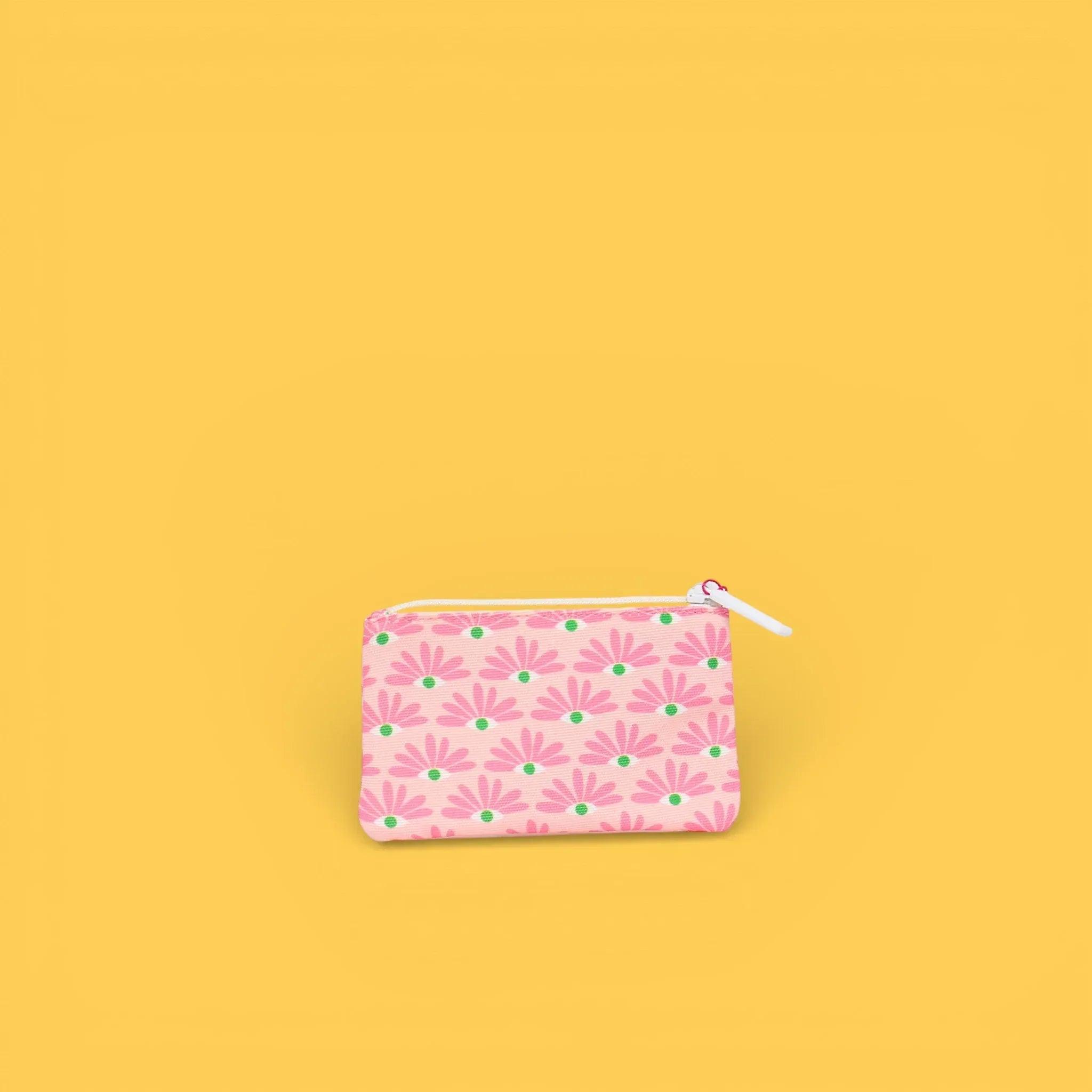 Monedero estampado rosa con cremallera blanca y flores.