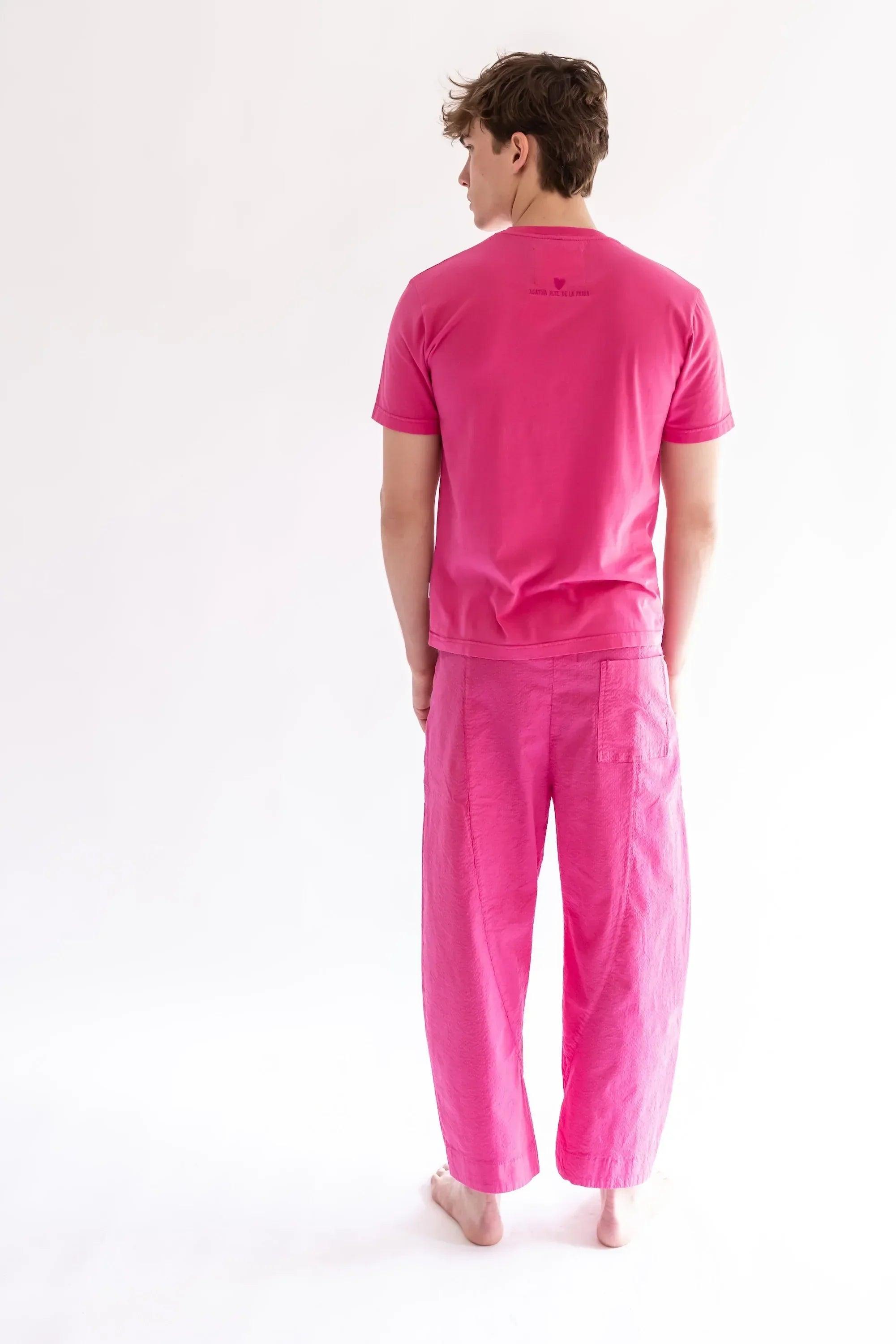 Camiseta fucsia de manga corta; vista trasera con logo pequeño en la nuca