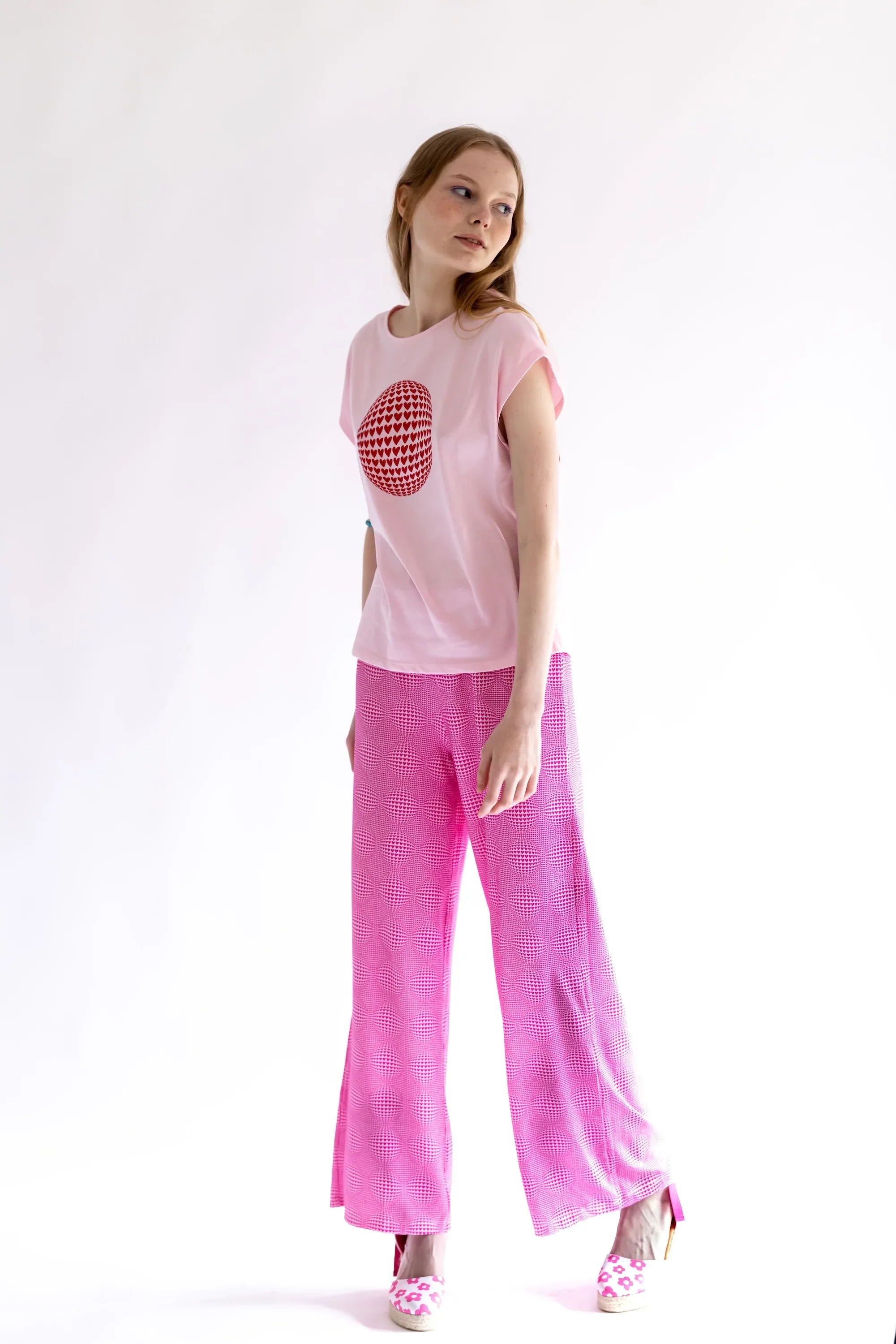 Pantalón rosa de pierna ancha con estampado de corazones; tiro alto suelto.