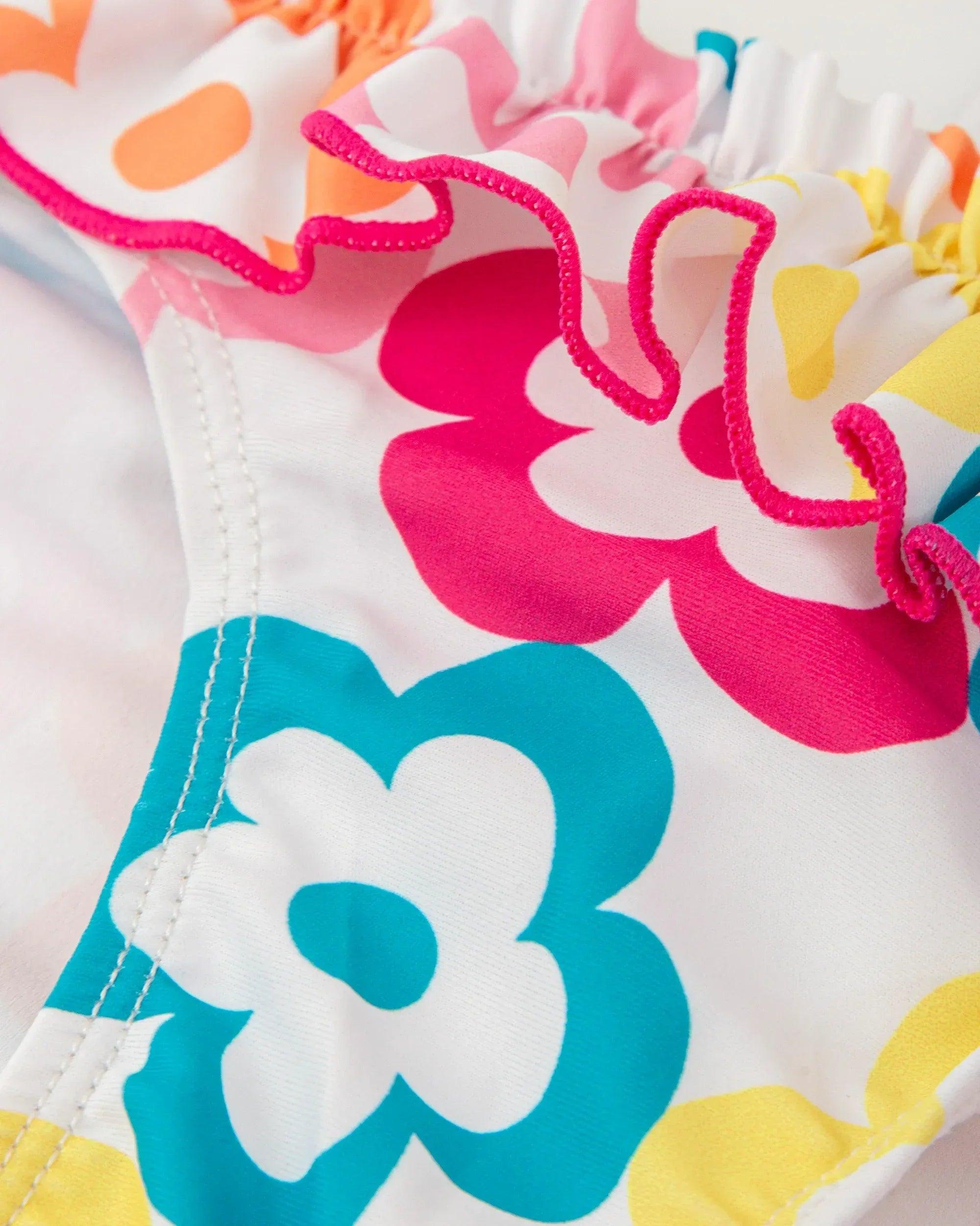 Tela de bikini de licra con flores grandes fucsia, turquesa y puntadas visibles