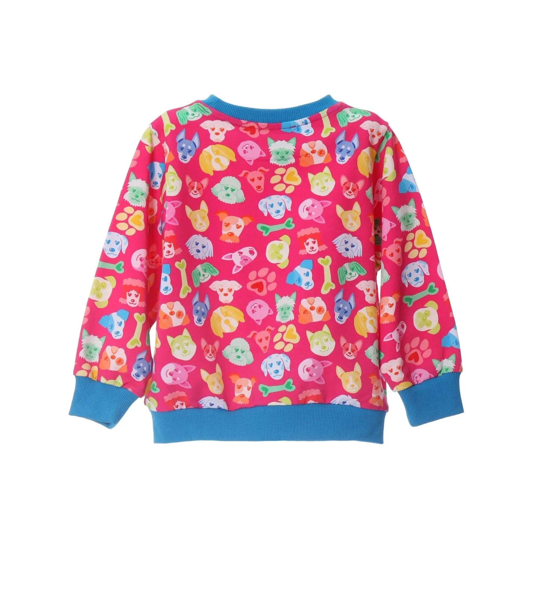 Sudadera estampada de perritos coloridos, manga larga, fondo rosa y ribetes azules.
